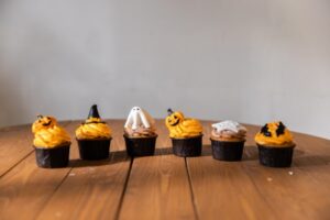 Unterschiedlich dekorierte Halloween Muffins stehen in einer Reihe